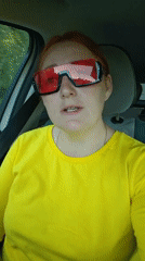 Woman in yellow shirt drives through Chaikovsky, Russia