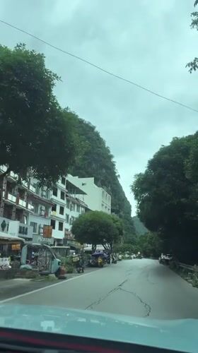 Dawn drive through Guilin village shows cracked roads, white buildings