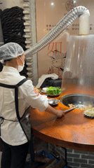 Chef prepares hot pot dishes at Wulingyuan restaurant
