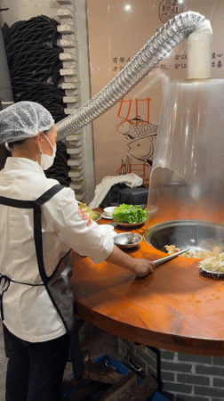 Chef prepares hot pot dishes at Wulingyuan restaurant
