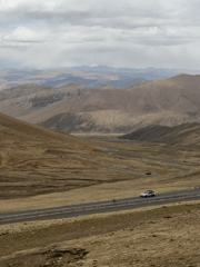 Morning traffic navigates mountain roads near Zagor, China