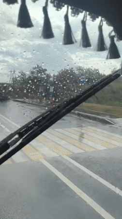 Rainy road conditions viewed from inside a vehicle in Yurivka