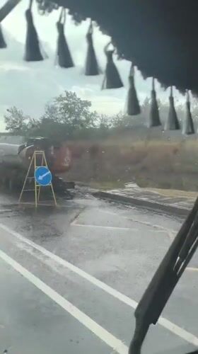 Rainy road conditions viewed from inside a vehicle in Yurivka