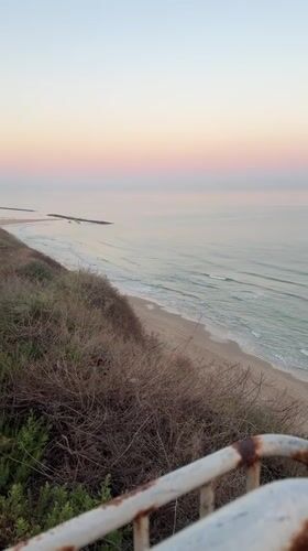 Dawn beach scenes captured along Netanya coastline with recreational activities