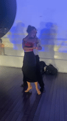 Tango dancers perform in Buenos Aires amid blue stage lighting