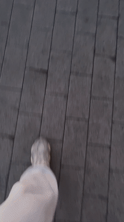 Person walks across wooden-to-tile walkway in Bor, Russia