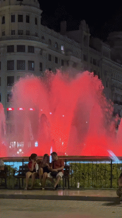 Colorful fountain lights up a València night scene