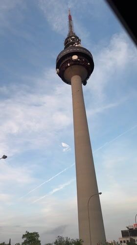 Telecommunications tower photographed against cloudy sky in Madrid