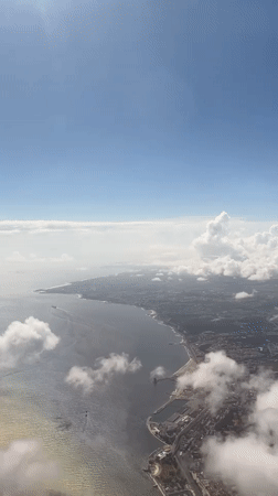 Aerial footage captures Almada's coastline under blue skies