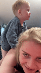 Toddler plays with mother in pink-lit Saint Petersburg room