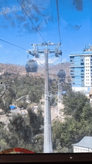 Cable car ride filmed over La Paz cityscape