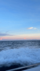 Boat passenger films serene seascape near Denpasar