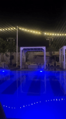 Blue-lit pool scene captured at night in Abuja