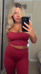 Woman takes mirror selfie in red outfit in Eilat