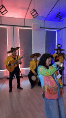 Mariachi band plays Zakharovo event, parrot watches from the window