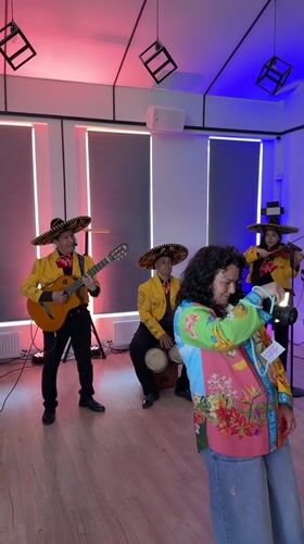 Mariachi band plays Zakharovo event, parrot watches from the window