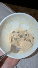 Person enjoys chocolate chip ice cream in Mishutkino