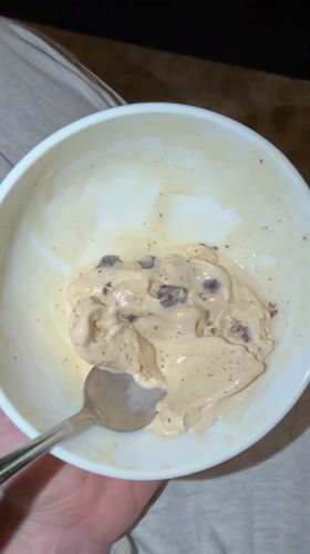 Person enjoys chocolate chip ice cream in Mishutkino