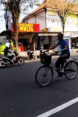 Morning street traffic and food vendors in Purworejo, Indonesia