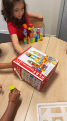 Kids build block towers and do coloring at a table in La Fouillouse