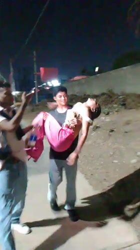 Man carries person on Porlamar sidewalk while being filmed