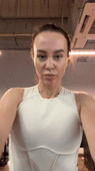 Woman poses playfully for camera at Russian gym