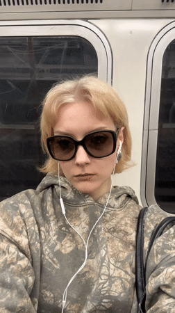 Woman in camouflage hoodie observed on train journey