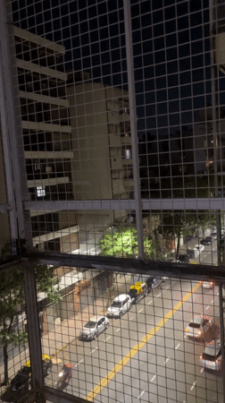 Nighttime street scene observed from balcony in Buenos Aires