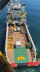 Supply vessel conducts container loading operations at Italian offshore platform