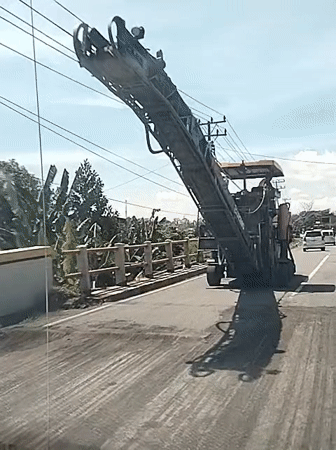 Industrial milling machine crosses bridge in Jurong Pandee, Indonesia