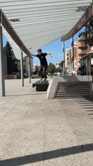 Skateboarder performs bench tricks in Terrassa park