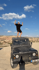 Man celebrates atop Land Rover in Göreme, Turkey