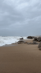 Tourist documents cloudy beach visit in Vila Nova de Gaia