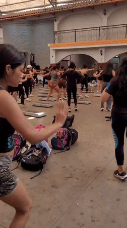 Aerobics step class in session at an open-air Lima gym