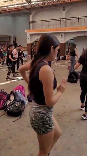 Aerobics step class in session at an open-air Lima gym