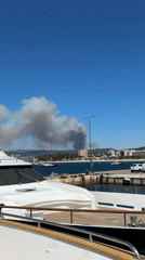 Dark smoke rises over the Palamós coastline