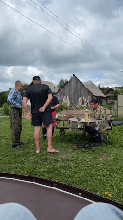 Rural gathering with dog captured in Zhigalki backyard