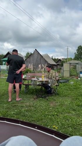 Rural gathering with dog captured in Zhigalki backyard