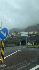 Car approaches tunnel in Faial, Madeira on cloudy afternoon