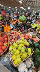 Browsing a Russian grocery store's fresh produce and snack aisles