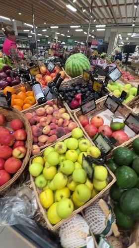 Browsing a Russian grocery store's fresh produce and snack aisles