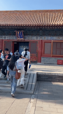 Visitors enter traditional building in Beijing's Dongcheng District