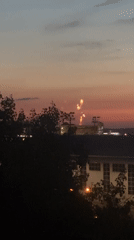 Fireworks light up a city skyline at twilight
