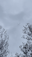 Aircraft spotted through clouds over Sofia skyline