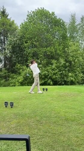 Golfer tees off under overcast skies in Hakadal