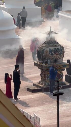 Religious gathering with incense ceremony observed in Kathmandu courtyard