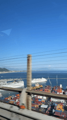 Clear skies over busy Salerno port captured from moving vehicle