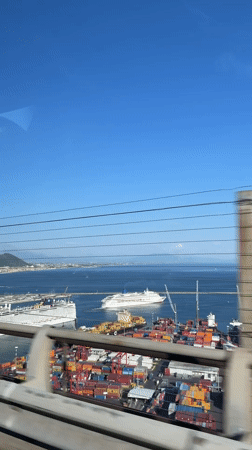 Clear skies over busy Salerno port captured from moving vehicle