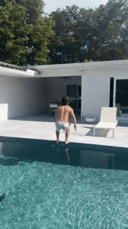 Young man performs flip dive into Hollywood pool