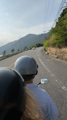 Motorcycle riders travel scenic coastal road in Đà Nẵng